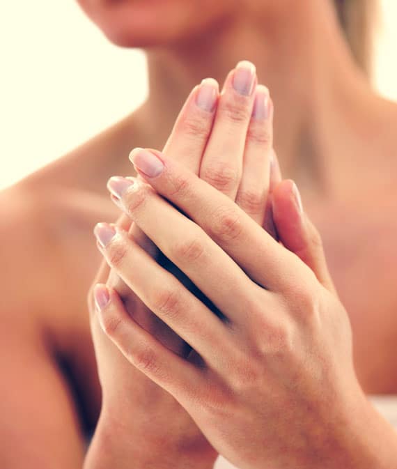 woman applying cleansing hand creme