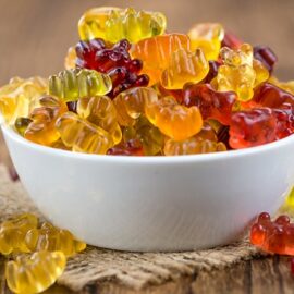 An overflowing bowl of gummies on a small table.
