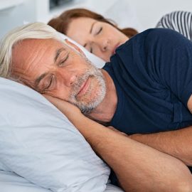older couple sleeping in a bed