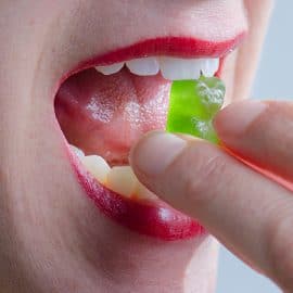 Close up of a woman eating a CBD edible.
