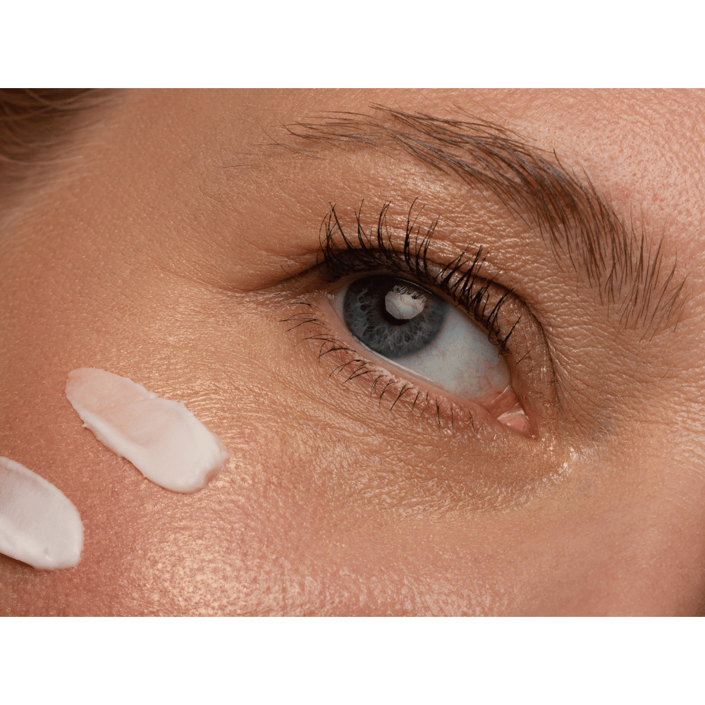 eye cream on close up of woman's eye